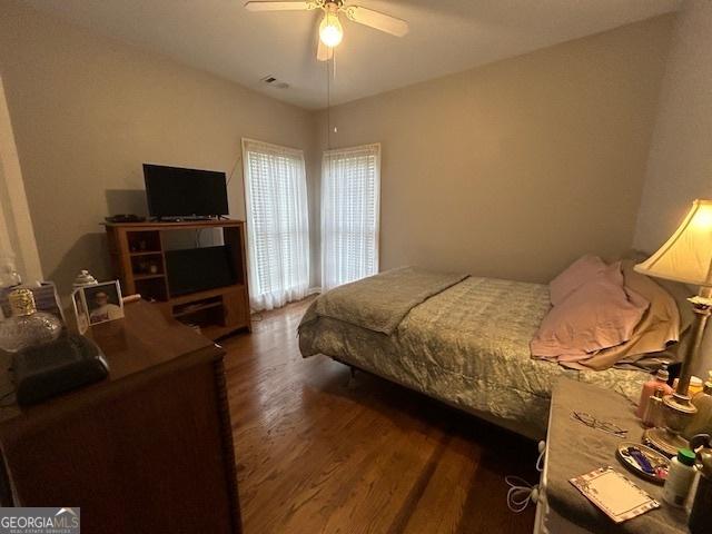 4665 Oakmont Bend Dr, Alpharetta, GA 30004 - bedroom with dark wood-style floors and a ceiling fan