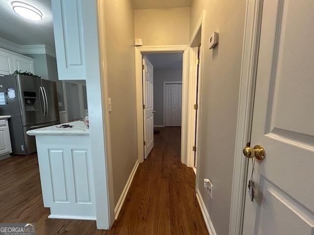 4665 Oakmont Bend Dr, Alpharetta, GA 30004 - hallway featuring dark wood-style floors, ornamental molding, and baseboards
