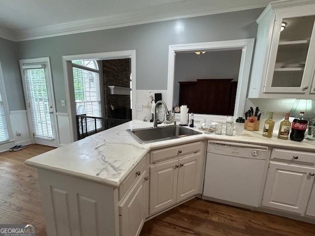 4665 Oakmont Bend Dr, Alpharetta, GA 30004 - kitchen with white dishwasher, a sink, dark wood-style flooring, ornamental molding, and white cabinetry