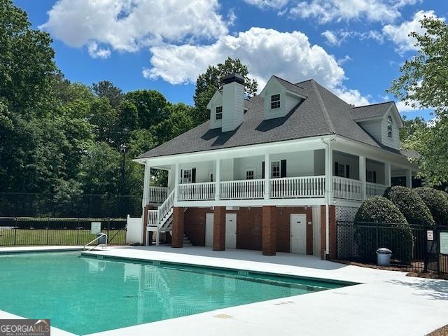 4665 Oakmont Bend Dr, Alpharetta, GA 30004 - back of property featuring a patio, stairway, a chimney, and roof with shingles
