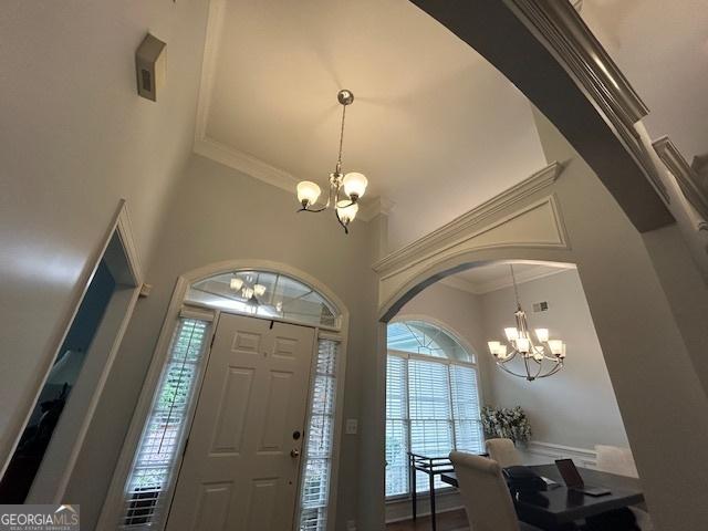 4665 Oakmont Bend Dr, Alpharetta, GA 30004 - entryway with a chandelier, a high ceiling, ornamental molding, and arched walkways