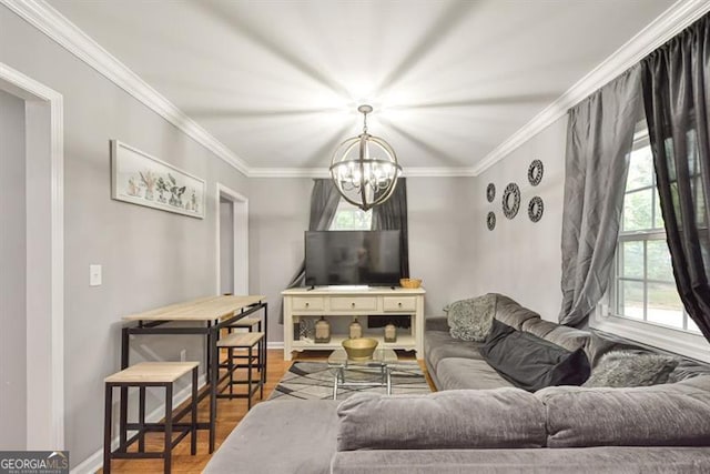 living room with a chandelier, baseboards, wood finished floors, and crown molding