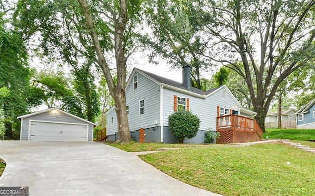 view of front facade with a chimney, a deck, an outdoor structure, a garage, and a front yard