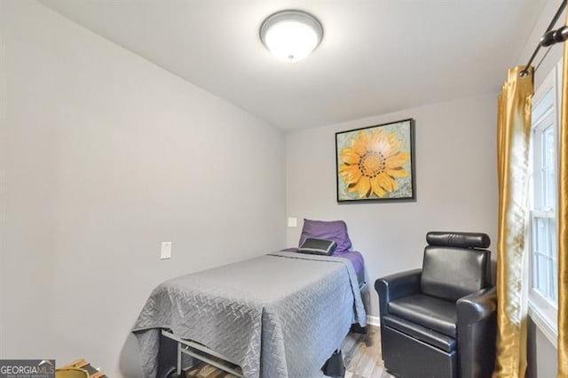 bedroom with baseboards and wood finished floors