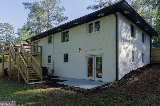2720 Cavalier Dr, Decatur, GA 30034 - rear view of property with brick siding, a wooden deck, and central AC unit