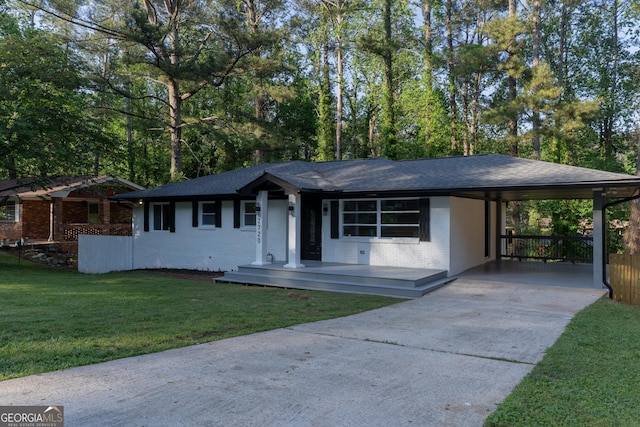 2720 Cavalier Dr, Decatur, GA 30034 - ranch-style home with brick siding, a shingled roof, an attached carport, driveway, and a front yard