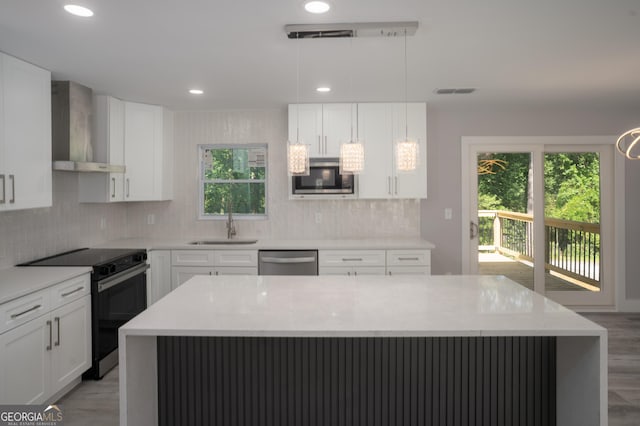 2720 Cavalier Dr, Decatur, GA 30034 - kitchen with wall chimney range hood, a healthy amount of sunlight, stainless steel appliances, and a sink