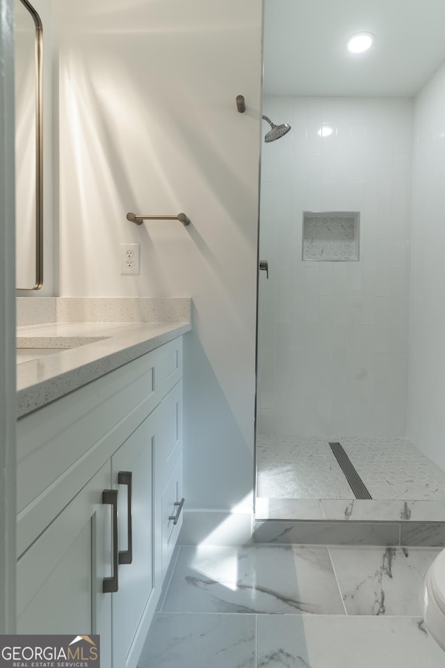 2720 Cavalier Dr, Decatur, GA 30034 - bathroom featuring recessed lighting, marble finish floor, tiled shower, and vanity
