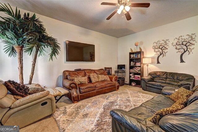 carpeted living room with a ceiling fan