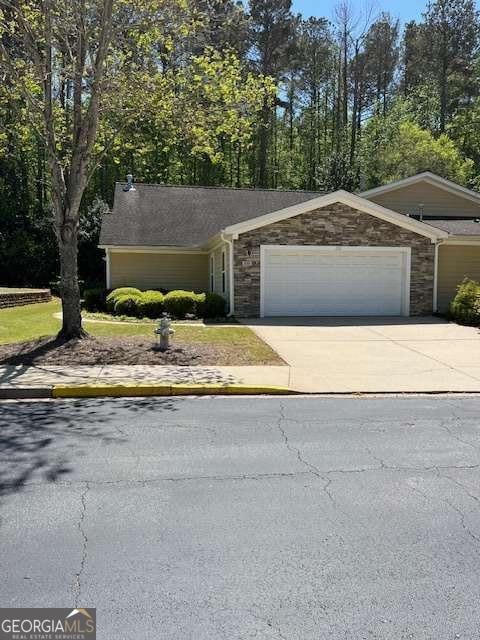 220 Rehobeth Way, Fayetteville, GA 30214 - ranch-style house with a garage, stone siding, and concrete driveway