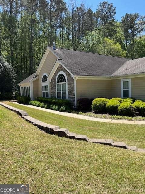 220 Rehobeth Way, Fayetteville, GA 30214 - view of home's exterior featuring a lawn and stone siding