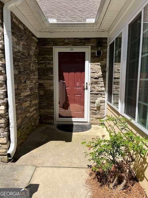220 Rehobeth Way, Fayetteville, GA 30214 - property entrance featuring roof with shingles and stone siding