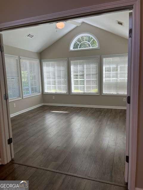 220 Rehobeth Way, Fayetteville, GA 30214 - unfurnished dining area with visible vents, dark wood-style flooring, baseboards, and vaulted ceiling