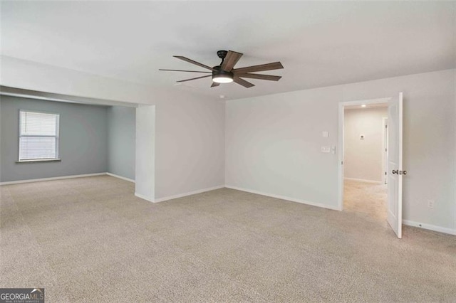 340 Paulownia Cir, Mcdonough, GA 30253 - spare room featuring a ceiling fan, light carpet, and baseboards