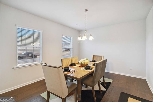 340 Paulownia Cir, Mcdonough, GA 30253 - dining space featuring wood finished floors, a notable chandelier, and baseboards