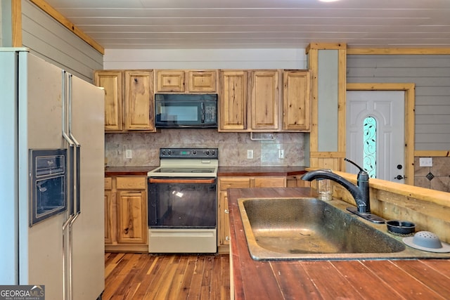 266 Ritchie Rd, Tiger, GA 30576 - kitchen with white appliances, dark countertops, backsplash, wood-type flooring, and a sink