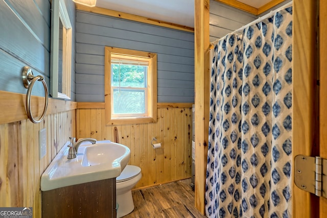 266 Ritchie Rd, Tiger, GA 30576 - bathroom featuring a shower with shower curtain, wooden walls, toilet, wood finished floors, and vanity