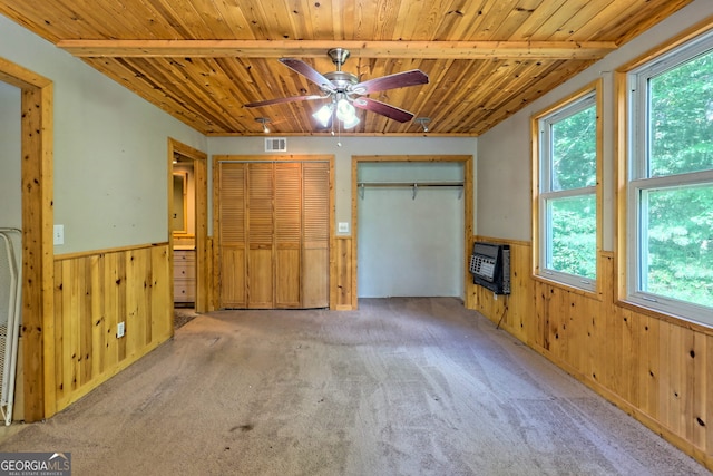 266 Ritchie Rd, Tiger, GA 30576 - unfurnished bedroom featuring wooden ceiling, a wainscoted wall, multiple windows, and multiple closets
