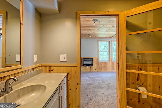 266 Ritchie Rd, Tiger, GA 30576 - bathroom featuring wooden walls, heating unit, vanity, and wainscoting