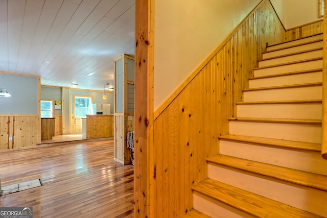 266 Ritchie Rd, Tiger, GA 30576 - staircase featuring wood walls, hardwood / wood-style flooring, a wainscoted wall, and wooden ceiling