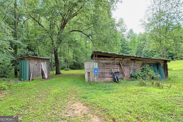 266 Ritchie Rd, Tiger, GA 30576 - view of yard featuring a wooded view, a storage unit, and an outdoor structure