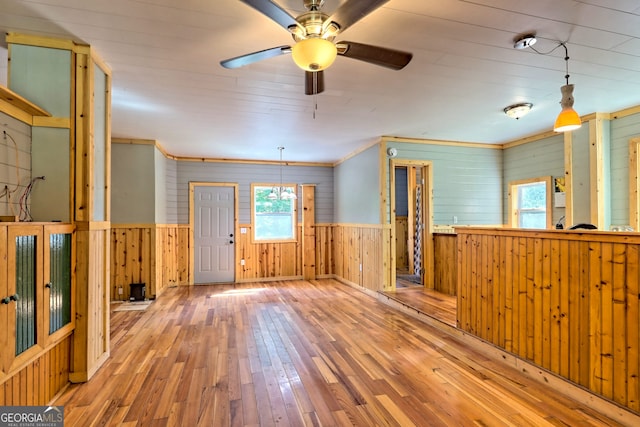 266 Ritchie Rd, Tiger, GA 30576 - unfurnished room with hardwood / wood-style floors, wood walls, a wainscoted wall, ceiling fan, and crown molding
