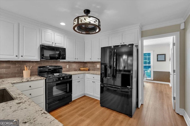 kitchen featuring crown molding, light wood-style flooring, black appliances, and white cabinetry