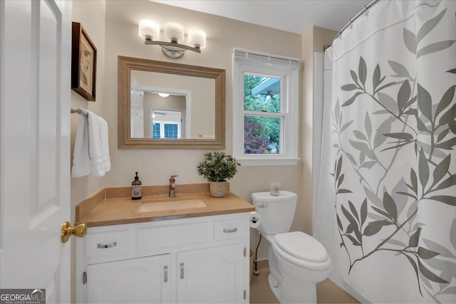 bathroom featuring toilet and vanity