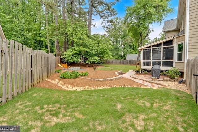view of yard with a fenced backyard and a sunroom