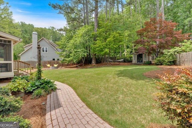 view of yard with fence and a sunroom