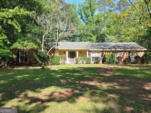 single story home featuring a front lawn and brick siding