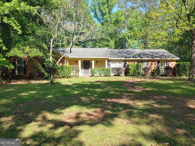 ranch-style home with a front yard and brick siding