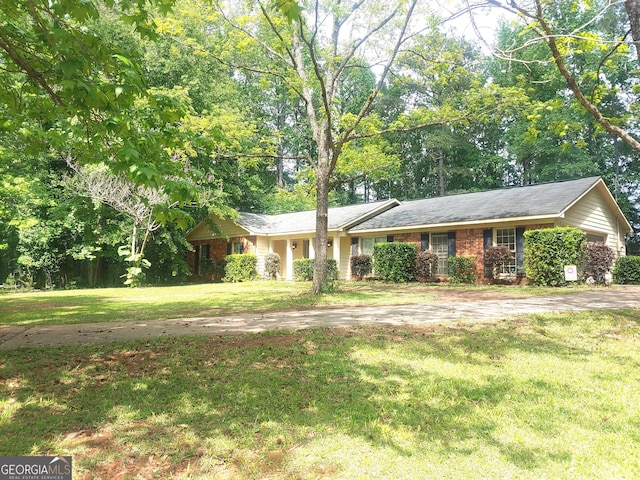 ranch-style home with a front lawn and brick siding