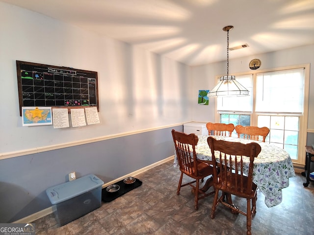 dining room featuring baseboards and visible vents