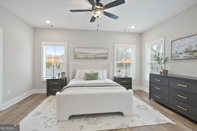 bedroom featuring recessed lighting, ceiling fan, wood finished floors, and baseboards