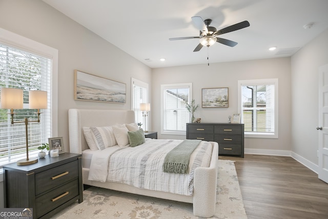 bedroom with recessed lighting, ceiling fan, wood finished floors, and baseboards