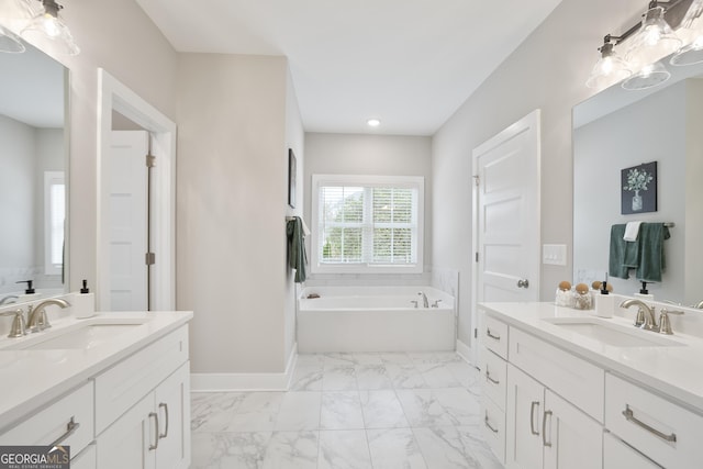 full bathroom featuring two vanities, a sink, and baseboards