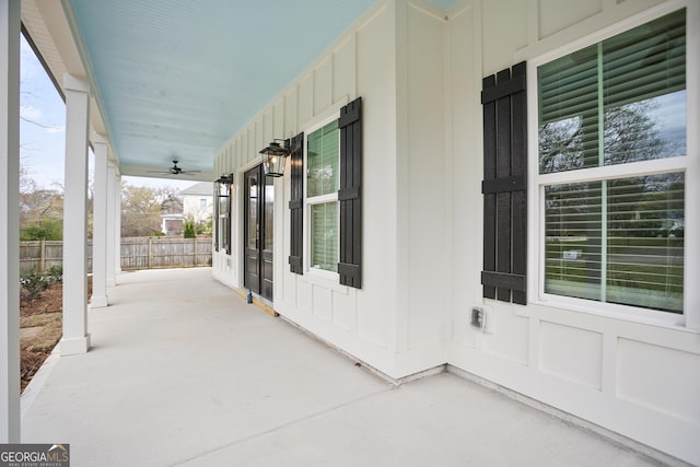 view of patio / terrace with ceiling fan, covered porch, and fence