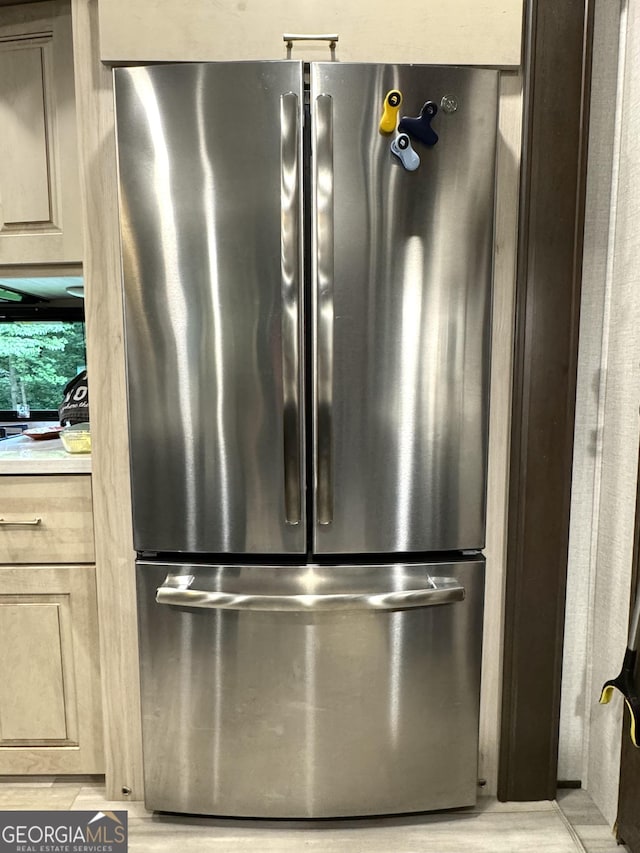 interior details featuring light countertops and freestanding refrigerator