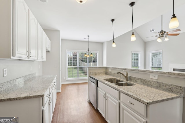 kitchen with a sink, stainless steel dishwasher, wood finished floors, white cabinetry, and a ceiling fan