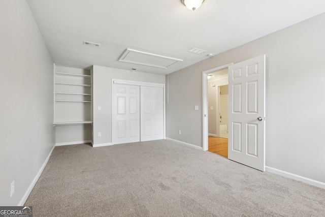 unfurnished bedroom featuring a closet, carpet, and baseboards