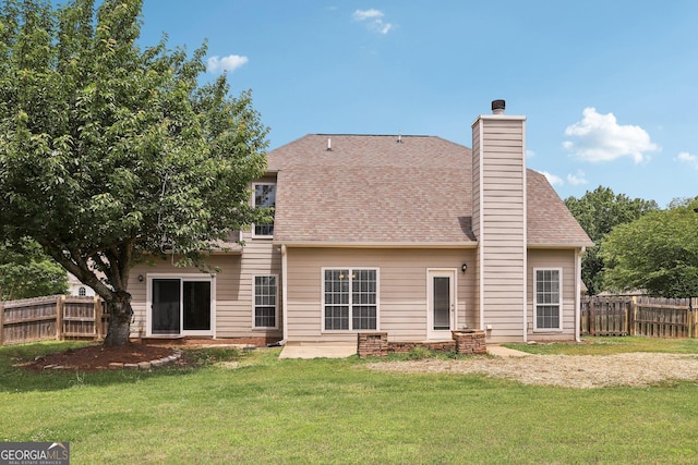 back of property featuring a shingled roof and a chimney