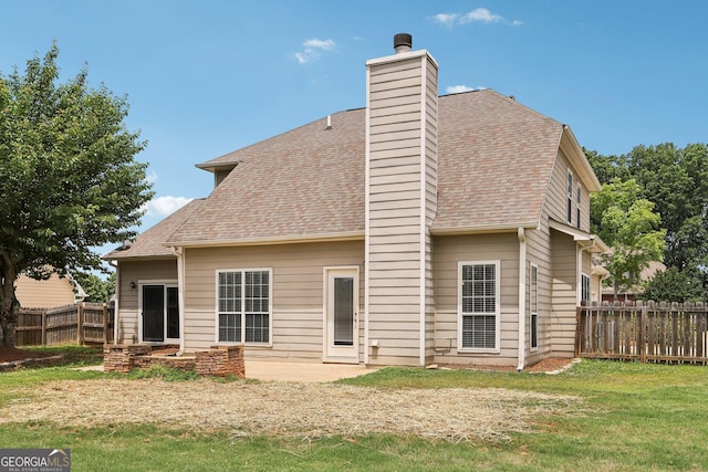 back of property with a chimney and roof with shingles