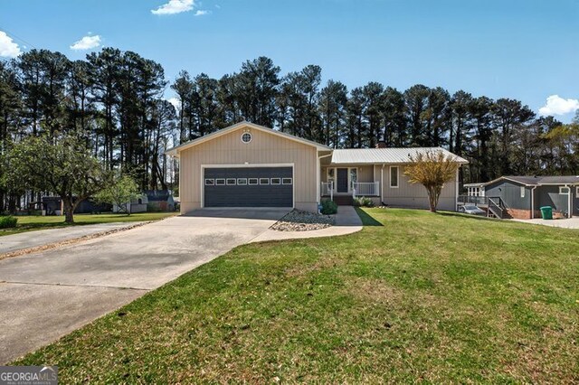 ranch-style house featuring concrete driveway, a front lawn, and a garage