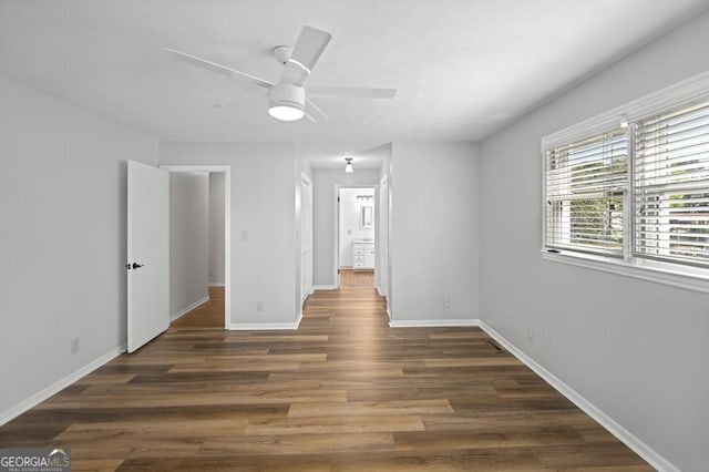 interior space with wood finished floors, ceiling fan, and baseboards