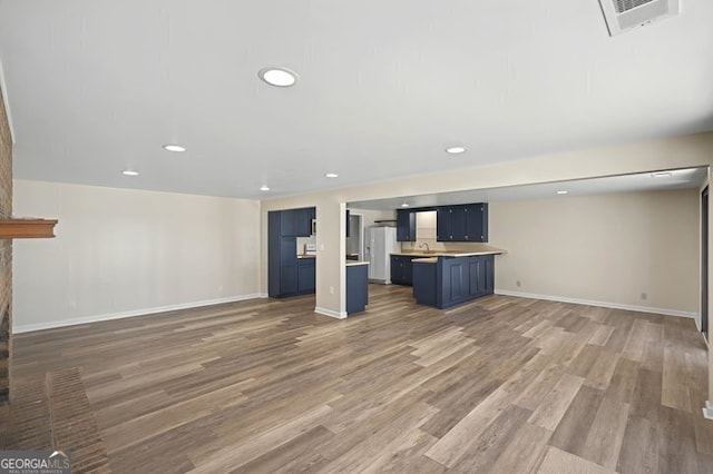 unfurnished living room featuring recessed lighting, visible vents, baseboards, and light wood-type flooring