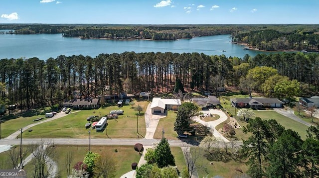 aerial view featuring a forest view and a water view