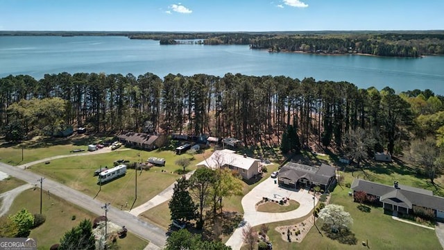 birds eye view of property with a water view and a view of trees