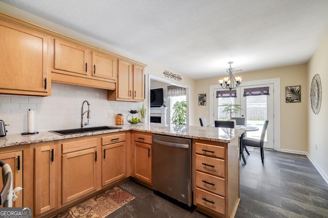 kitchen with a sink, dishwasher, a peninsula, a notable chandelier, and backsplash