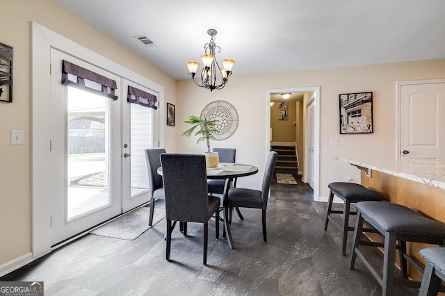 dining area with visible vents, french doors, plenty of natural light, and a chandelier
